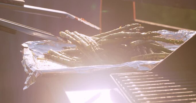 Fresh asparagus cooking on a bbq grill on a summer afternoon