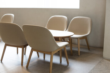 chairs and table in bright modern interior with white wall.
