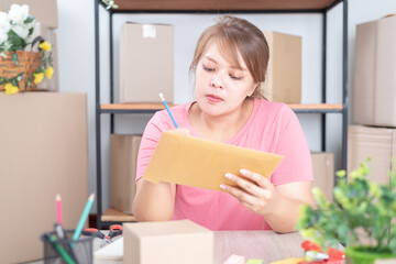 Packing products for delivery.Woman holding in hand a small paper box. Packing products for delivery