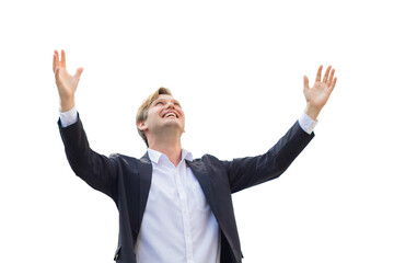 Celebrating success.Excited cheerful young businessman keeping arms raised and expressing positivity while standing isolated on white background