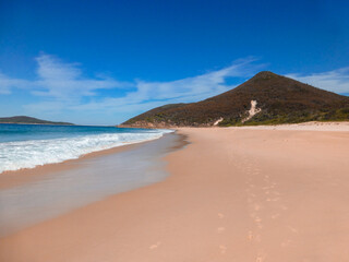 Beach with view of Island over sand and Blue Sky