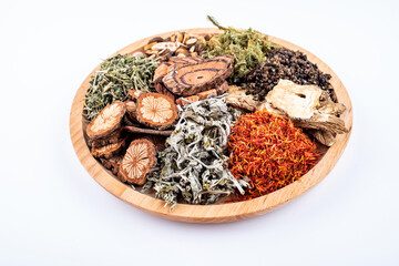 Chinese herbal medicine for soaking feet in a saucer on white background