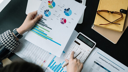 Close up Businessman using calculator and laptop for calculating finance, tax, accounting, statistics and analytic research concept