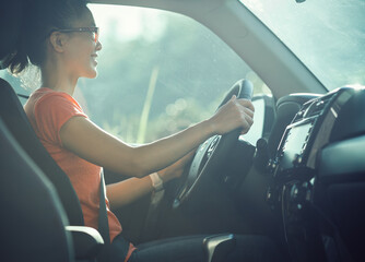 Asian woman driver driving off road car in the nature