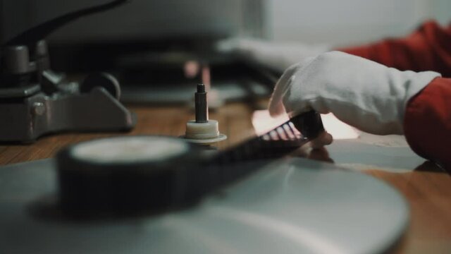 film strip on the editing table, with a man who works there.