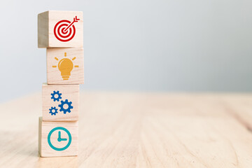 Concept of business strategy and action plan. Wood cube block stacking with icon