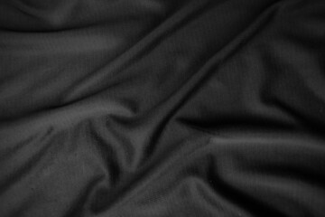 Background texture black cloth. Abstract dark wavy soft. Fabric is wrinkled. Fashion luxury style.