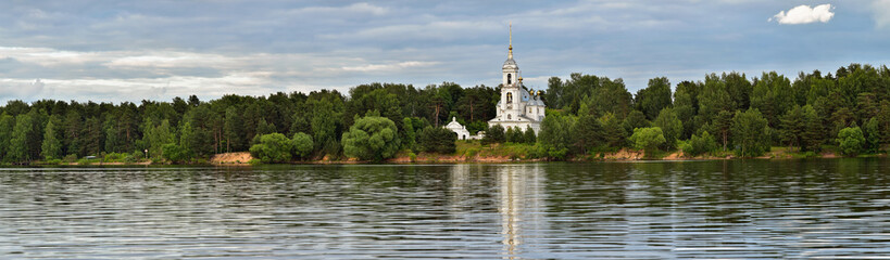 Fototapeta na wymiar Panoramic Landscape with River, Forest and Orthodox Temple on the far Bank
