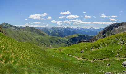 Fototapeta na wymiar San Marco mountain pass, Italy. Amazing landscape of the Alps on a sunny day. Contrast between the green of the meadows and the blue of the sky. Italian alps. North Italy