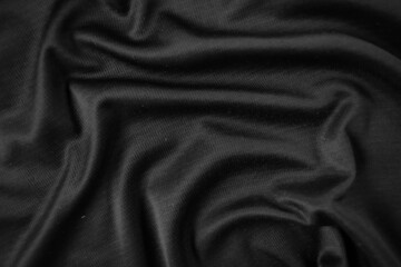 Background texture black cloth. Abstract dark wavy soft. Fabric is wrinkled. Fashion luxury style.