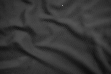 Background texture black cloth. Abstract dark wavy soft. Fabric is wrinkled. Fashion luxury style.