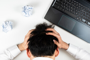 a man with his hands wrapped around his head.