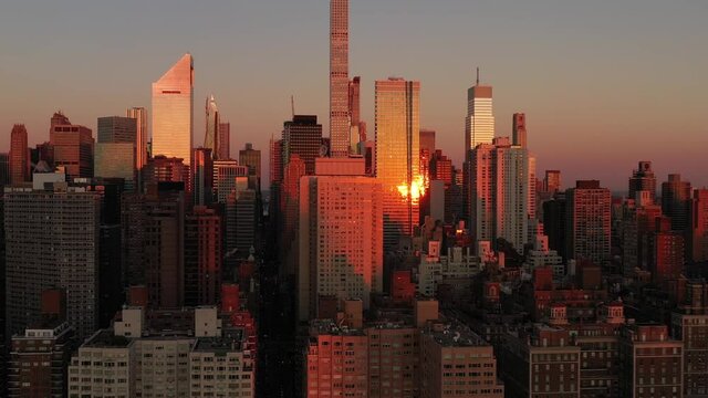 Epic aerial trucking shot of Manhattan New York City at sunrise golden hour (from the East River)