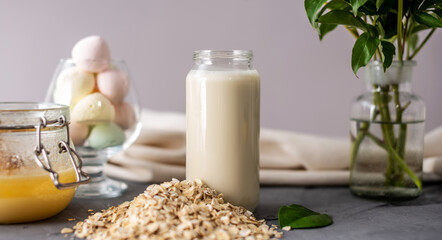 Vegetable natural oat milk on the table. Alternative vegetarian drink for a healthy diet