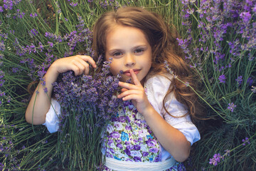A child in lavender. Beautiful girl in a field with lavender.