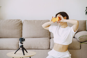 Woman with fruits. Nutritionist shoots a blog.
