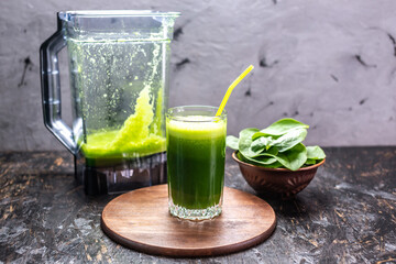 Cooking a vegetarian smoothie from leaves of fresh spinach. Popular detox drink for healthy eating