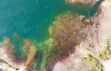 green lake with brown border aerial view