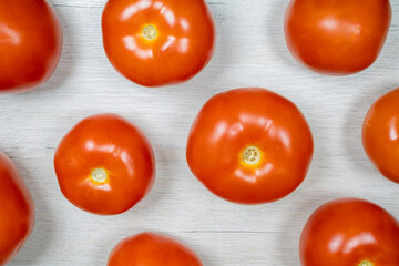 Tomatoes on bleached wood. Background on the theme of tomatoes.