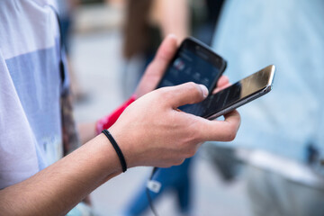 man hand phone in street