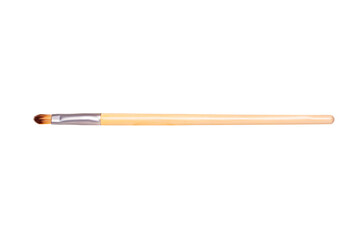 Closeup of a wooden new professional makeup brush isolated on a white background. Concept beauty. Macro photograph.