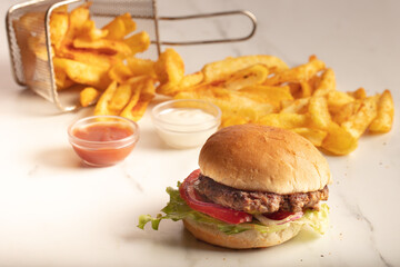 Still life with fast food hamburger menu, french fries and ketchup.Junk food. Fast carbohydrates not good for health