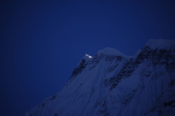 snow covered mountain at night