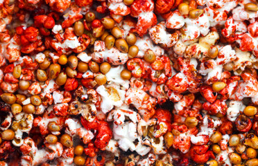 Sweet popcorn behind glass as an abstract background.