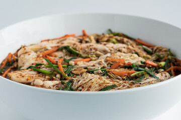 Close up traditional Korean dish kimchi in a white plate on a white background