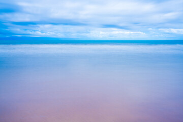 Sea landscape and sandy beach in the morning Fog against the background of a cloudy at sun rise time.Chanthaburi Coast, Thailand.soft focus.