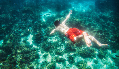 young man snorkeling in the sea