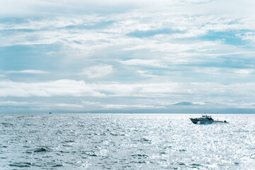 sea, boat and sky with clouds