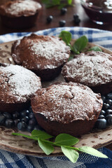 Brown chocolate muffins and blue berrries