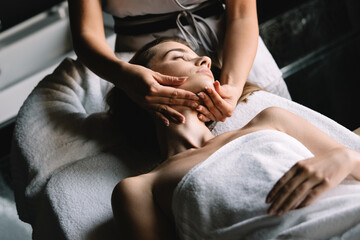Healthy woman having massage therapy at spa salon