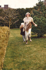 Obraz premium Family in a garden. Mother with daughter. People with little dog.