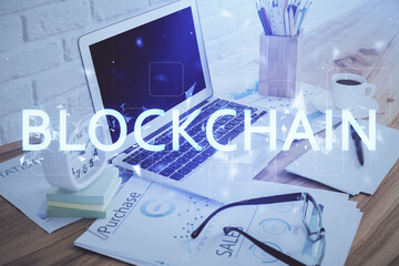 Fototapeta premium Double exposure of blockchain and crypto economy theme hologram and table with computer background. Concept of bitcoin cryptocurrency.