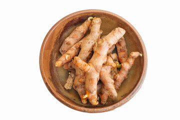 Fresh raw organic turmeric curcuma roots in bowl isolated on white background with clipping path