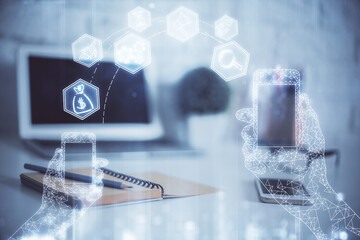 Computer on desktop in office with technology theme hologram. Multi exposure. Tech concept.