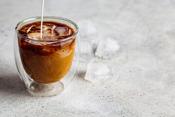 Ice latte coffee with milk and ice, white background, copy space.