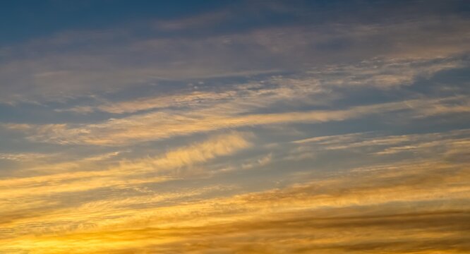 Beautiful Landscape Shot Of A Colorful Sky With White Cloud Streaks