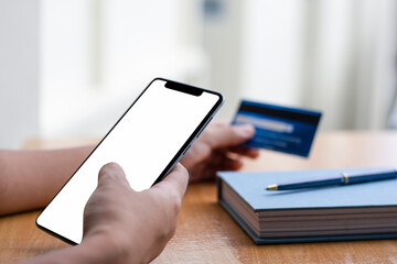 Mock up man hands using mobile smart phone with credit card for internet banking, online shopping...
