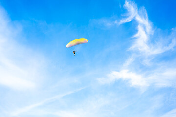 Fly on paramotor On the blue sky and white clouds