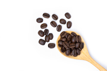 Closeup roasted coffee bean in wooden spoon isolated on white background. Top view. Flat lay.