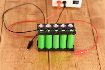 Li ion 18650  battery holder on the wooden table.