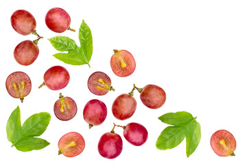 Grapes fruit with half slice and green leaf pattern texture background. Top view. Flat lay.