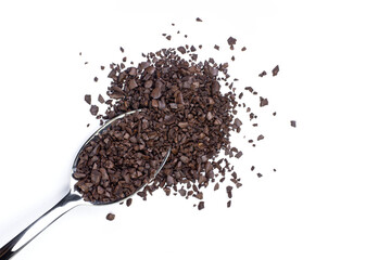 Instant granular coffee in stainless teaspoon isolated on white background. Top view. Flat lay.