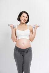 Fototapeta na wymiar Pregnant woman lifting dumbbell on white background