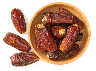 dried date palms in the wooden bowl, isolated on white background, top view