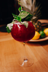  Fresh Cherry summer  Author inspired Cocktail Drink - on bar counter on Pineapple fruits Background  . Close-up Top view . Copy paste space for design people and luxury service barman in nightclub