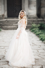 Obraz premium Beautiful bride spinning with perfect dress in the park